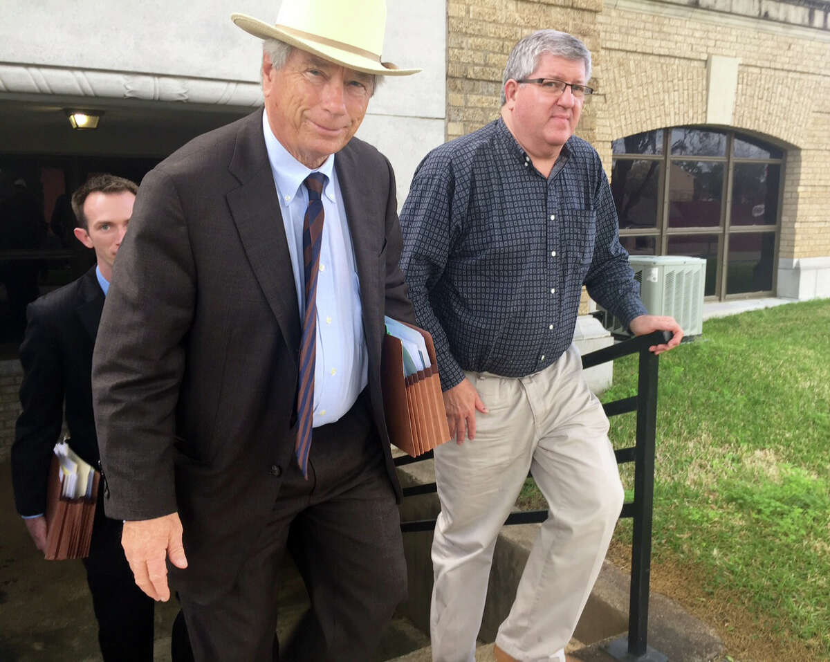 Houston attorney Mike DeGeurin, left, and Bernie Tiede, whose murder of a wealthy widow inspired a film, leave the Rusk County Courthouse on Thursday.