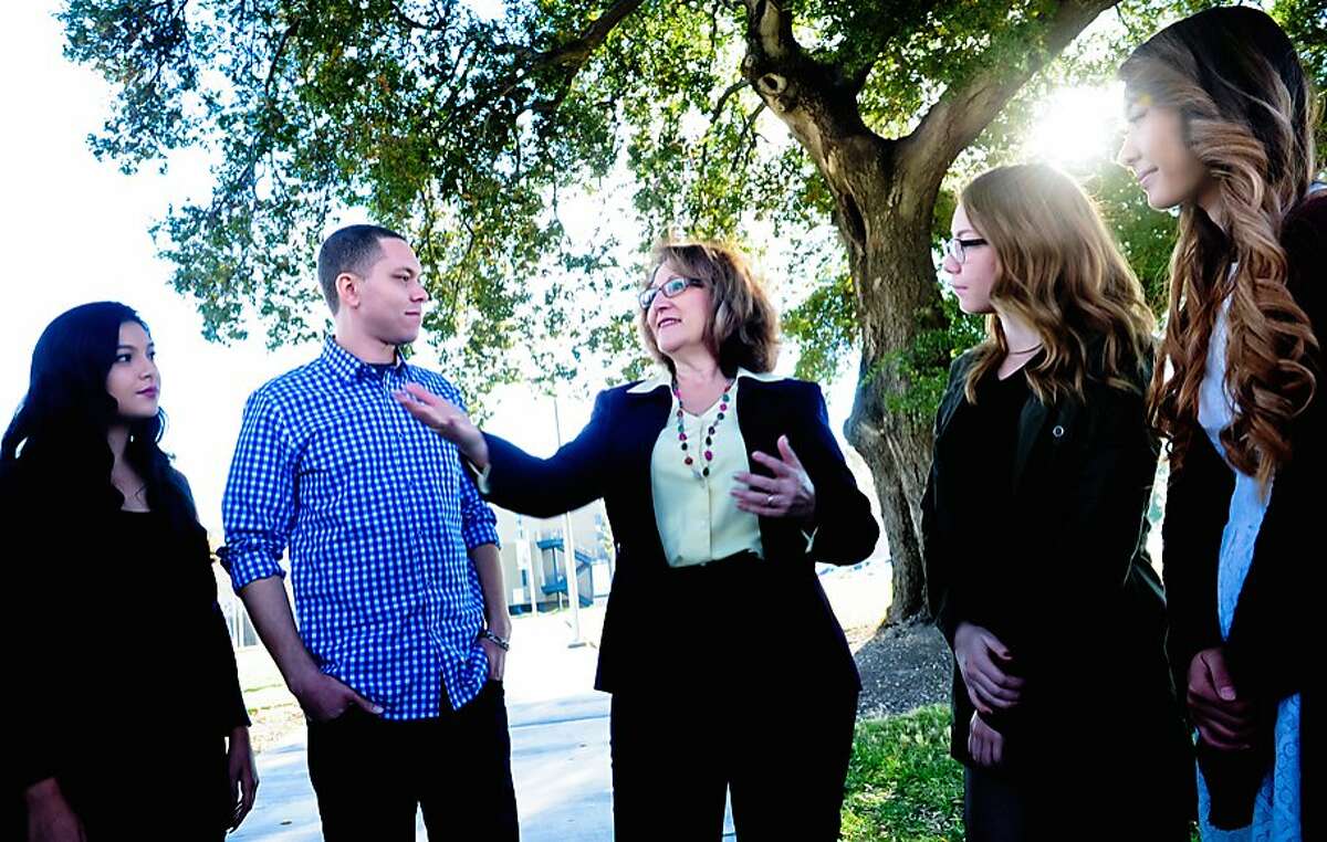 In this undated photo provided by the Eloise Reyes for Assembly 2016, Eloise Reyes, center, a member of the board of directors of San Bernardino Valley College, is seen at the schools campus in San Bernardino, Calif. Reyes, a Democrat, is challenging fellow Democrat, incumbent Assemblywoman Cheryl Brown, of San Bernardino, for the 47th Assembly District seat. (Violeta Vaqueiro/Eloise Reyes for Assembly 2016 via AP)