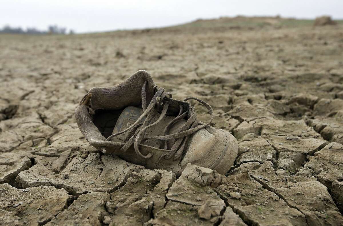 In this photo taken Tuesday Oct. 27, 2015, a shoe sits on the dry lake bed at Folsom Lake, in Folsom, Calif. The State Water Resources Control Board is expected to release statewide water conservation figures for October at a water board meeting Tuesday, Dec. 1. (AP Photo/Rich Pedroncelli)