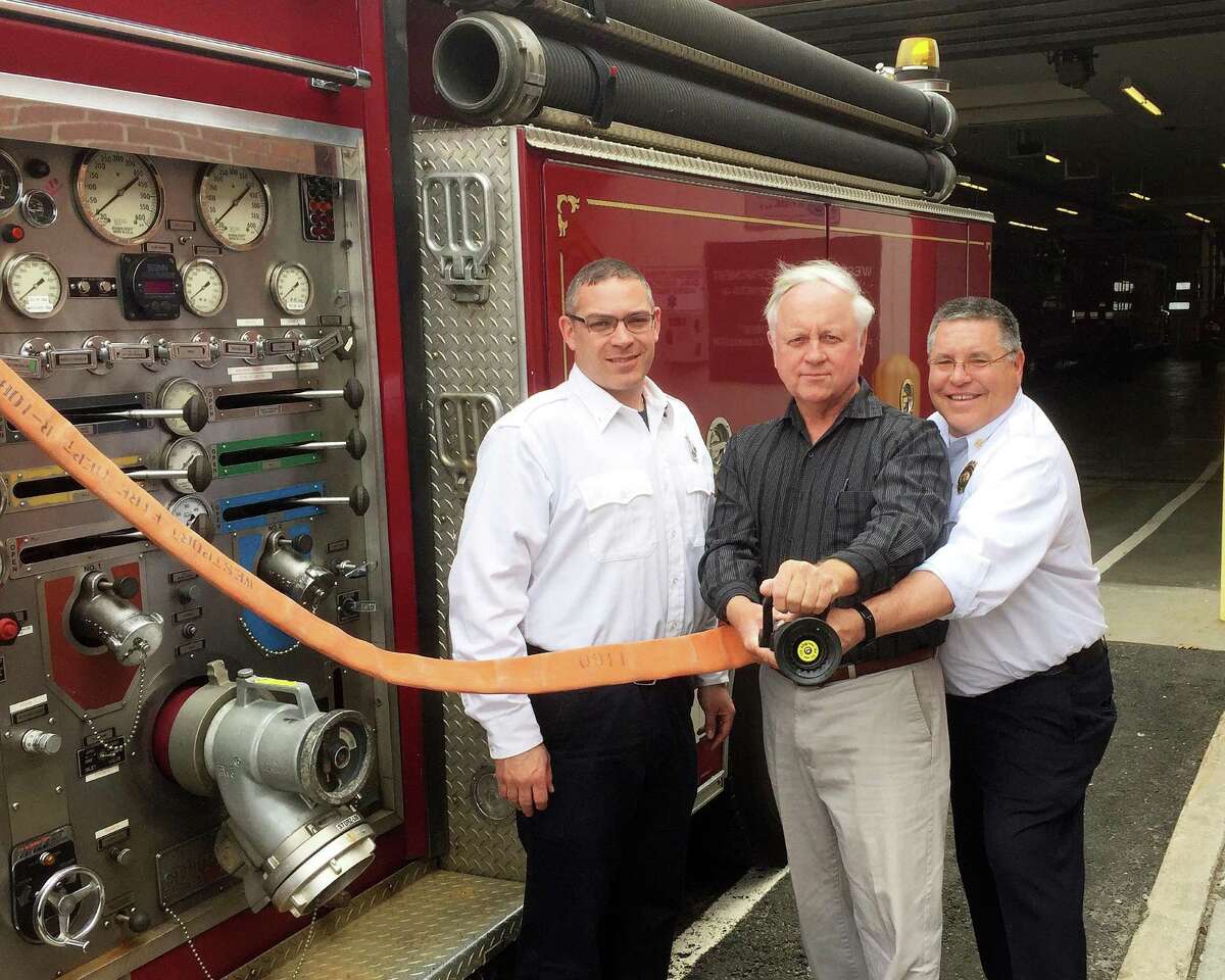 Showing off new hoses and nozzles acquired with help from a donation from Fairfield Half Marathon proceeds are, from left, fire Lt. Jeff Gootman; Steve Lobdell of the Fairfield Half Marathon, and Deputy Fire Chief Robert Kepchar.