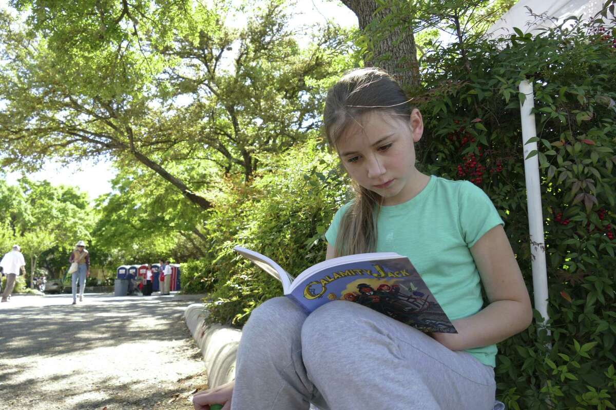 Catherine Day catches a quiet moment to read during last year’s San Antonio Book Festival.