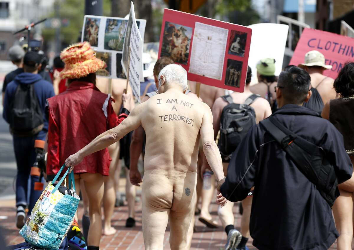 People march down Market Street from Jane Warner Plaza during a nude parade...