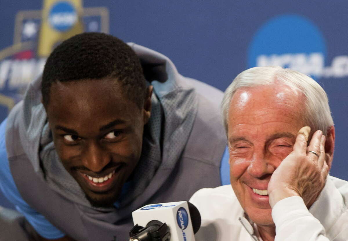 North Carolina forward Theo Pinson sneaks up behind head coach Roy Williams during a news conference before the NCAA basketball championship at NRG Stadium on Sunday, April 3, 2016, in Houston.