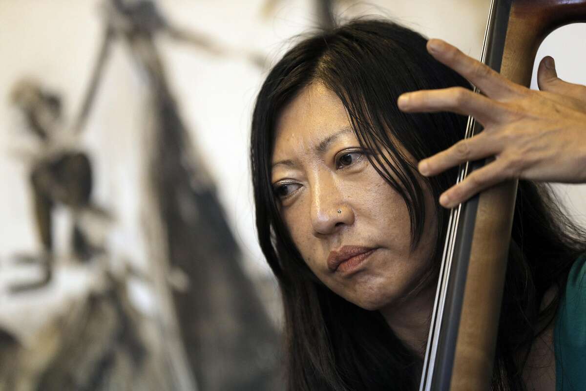 Caroline Chung stepped in to play bass during a jazz jam session at Noise in San Francisco, Calif., on Sunday, April 3, 2016. Daniel Brown, 27, and his mother, Sara Johnson , 59 have opened a storefront record store and art gallery. Dan is a professional sax player and on Sunday afternoon from 3 to 6 he holds a jam session in the back of the store. Professional jazz players come from all over to play while people sit and listen and others browse through racks of classic rock and jazz vinyl.