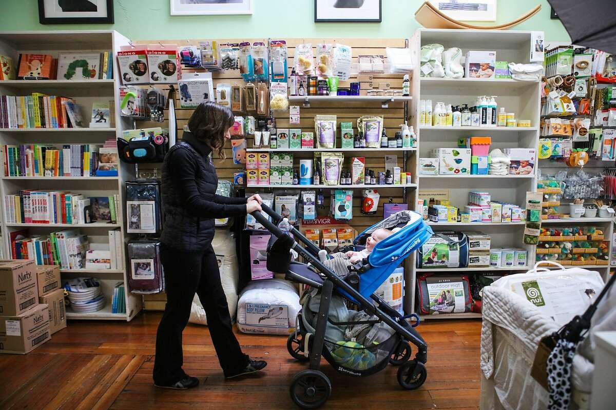 New mom Rose Collins, 36, shops for a new outfit with son Jack Collins, 4 months, at Natural Resources maternity store in San Francisco, California on Tuesday, January 12, 2016.