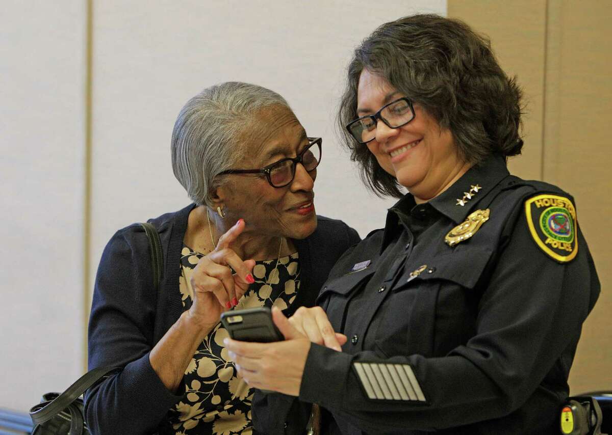 Era Mae Howard, left, mother of slain officer Elston Howard, looks at photos of interim HPD Chief Martha Montalvo's children - whom Howard used to babysit - at the Monday hearing where an execution date was set for the killer. ﻿
