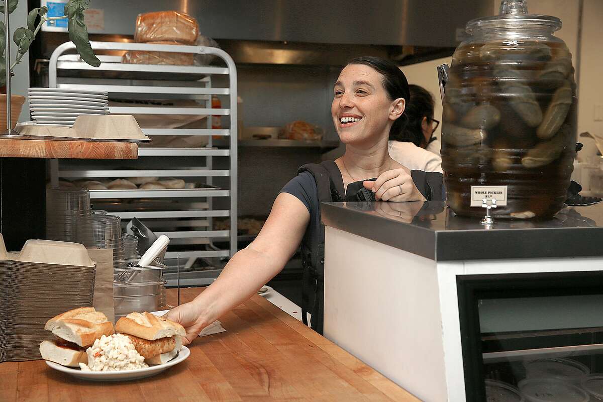 Co-owner Christina Stobing serves a sandwich at the vegan butchery and restaurant Butcher's Son in Berkeley, California on thursday, march 31, 2016.