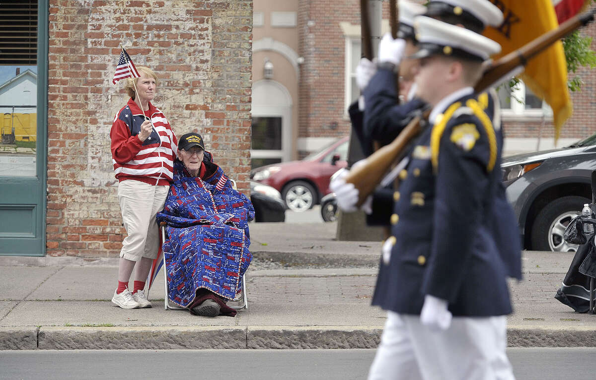 World War II Army Air Corps veteran Norman Jensen, 93, and his daughter Karen Covey watch as members of Christian Brothers Academy march by in the Albany Memorial Day Parade on Monday, May 25, 2015, in Albany, N.Y. Jensen, who was a bombardier during the war, was the grand marshal of last years Veteran's Day Parade. (Paul Buckowski / Times Union)