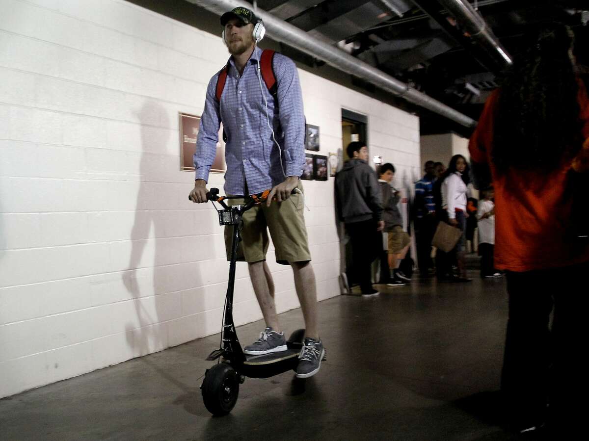 Giants' Hunter Pence rides his electric scooter away from the clubhouse after the San Francisco Giants beat the St. Louis Cardinals 6-1 in game six of the National League Championship Series, on Sunday Oct. 21, 2012 at AT&T Park, in San Francisco, Calif.