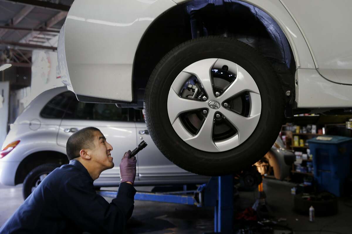 Mechanic Lanh Nguyen checks suspension and bushings on the Prius Wednesday April 8, 2015. San Francisco Auto Repair is an authorized inspection service center for personal cars driven for UberX. The technician spent almost 45 minutes checking everything from brakes to wheel life to warning lights and the engine for an almost new Toyota Prius.