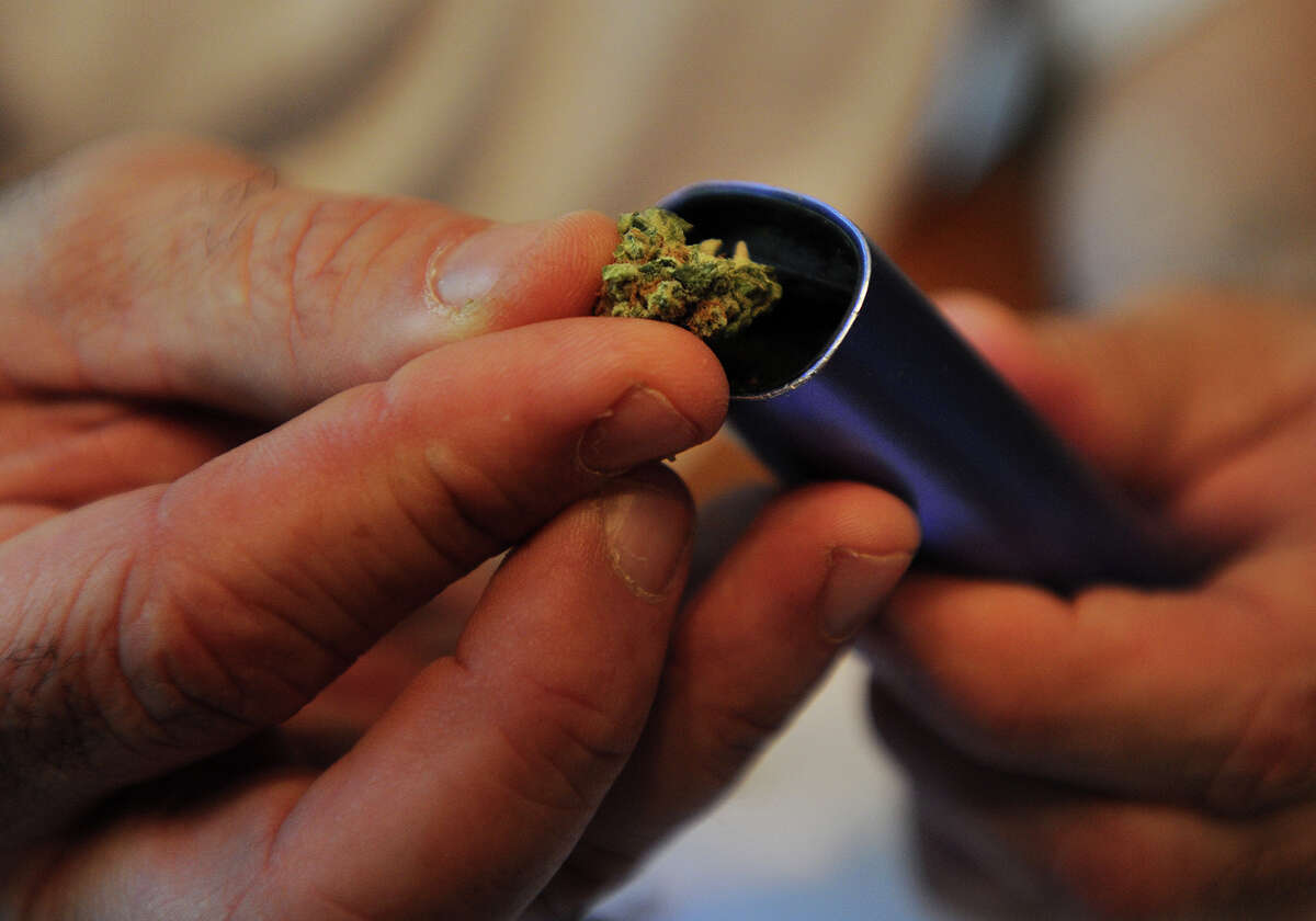 A marijuana flower being put into a vaporizer for a Connecticut medical-marijuana patient.