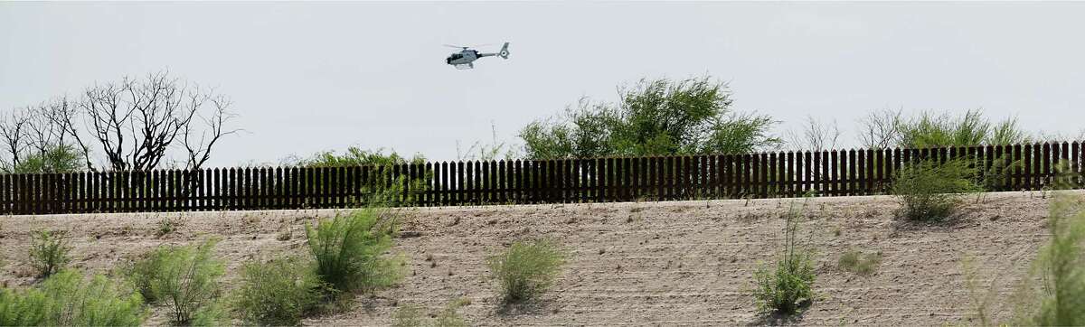 A U.S. Customs and Border Protection helicopter patrols the border along the existing border wall near the Hidalgo-Pharr International Bridge in the Rio Grande Valley. Donald Trump has proposed blocking wire transfers Mexicans send to relatives back home to compel Mexico to pay for an extended wall.