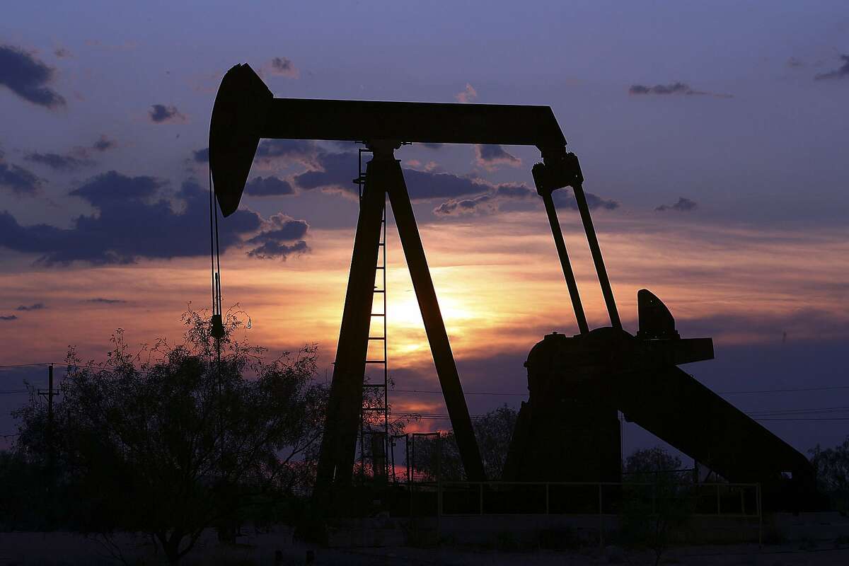 Oil Well pump is silhouetted against the West Texas sunset near Big Lake Tuseday August 22, 2006. DELCIA LOPEZ/STAFF