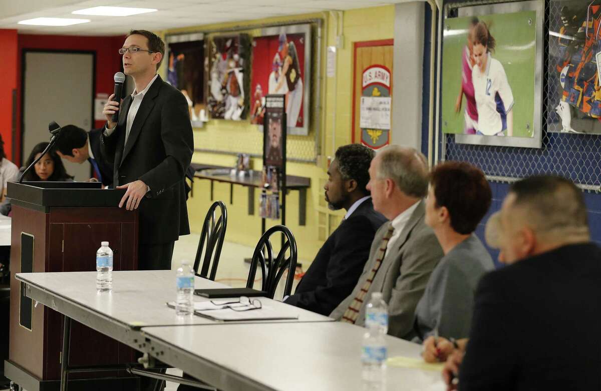 State education commissioner Mike Morath (left) addresses a crowded room of parents and educators from Edgewood Independent School District in 2016. The appointed Edgewood board should have let Morath fill a vacated seat.