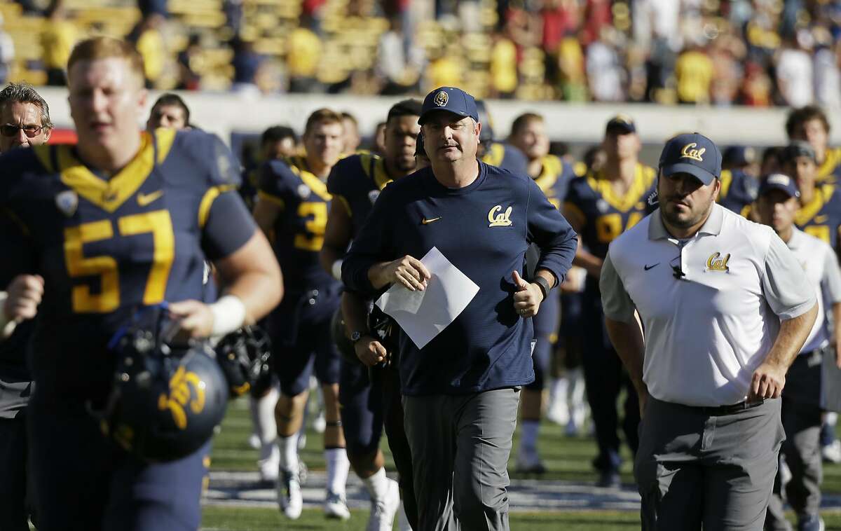 California head coach Sonny Dykes, center, runs off the field with his team at the end of an NCAA college football game against Southern California Saturday, Oct. 31, 2015, in Berkeley, Calif. USC won the game 27-21. (AP Photo/Eric Risberg)