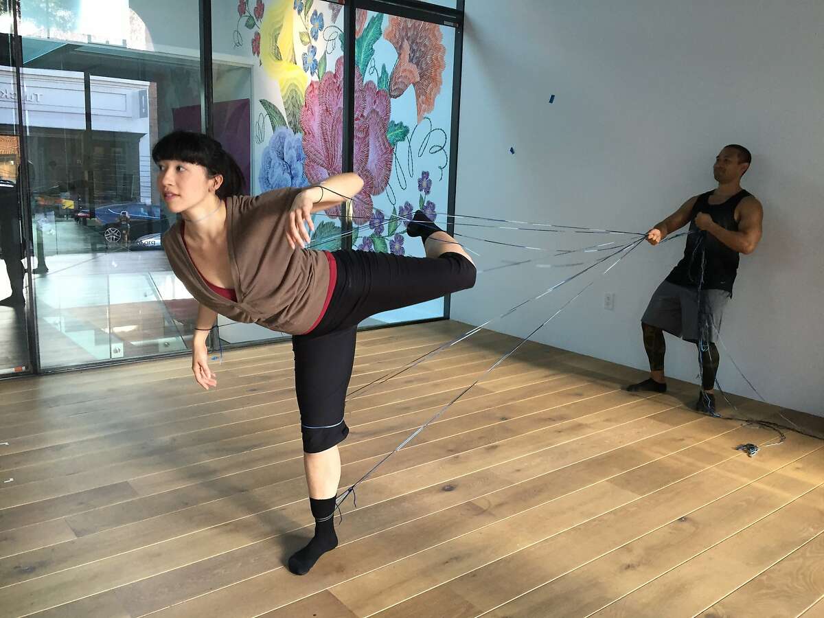 Linked by yarn, Katerina Wong and Kelly Del Rosario rehearse a section of RAWdance�s site-specific work at 836M Gallery. The ongoing project culminates in a final showing on June 3. Photo by Claudia Bauer