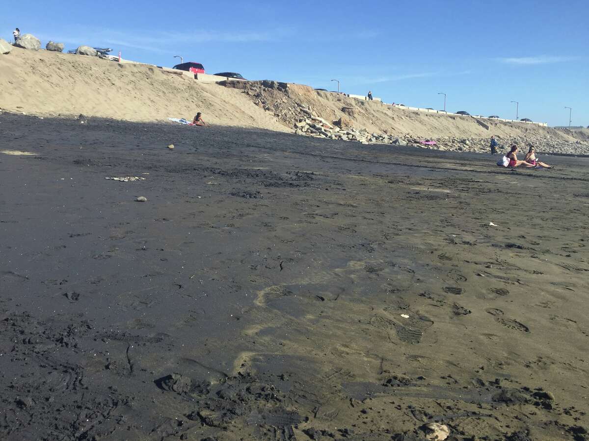 Black magnetite sand covered parts of Ocean Beach on April 5, 2016.
