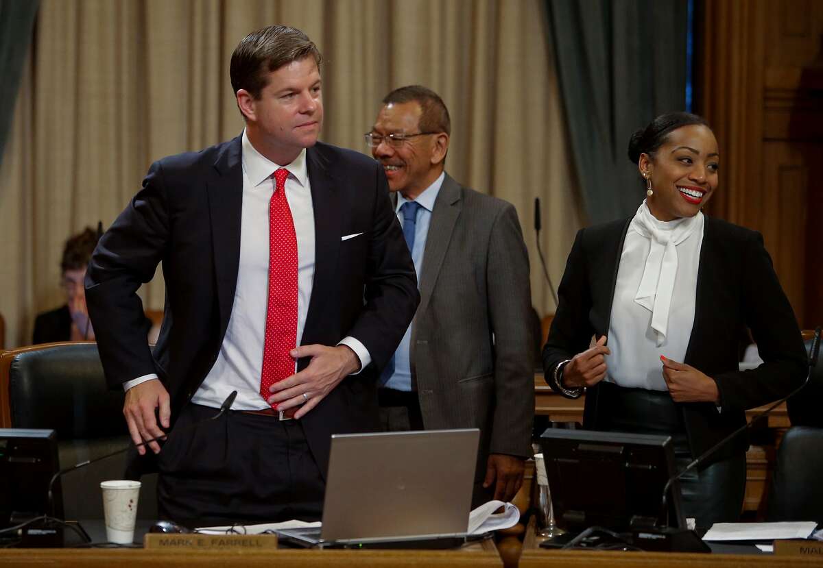 Supervisor Norman Yee, (center) congratulates fellow supervisor Mark Farrell, (left) as the San Francisco Board of Supervisors voted to pass the ordinance sponsored by Supervisor Mark Farrell and Mayor Ed Lee to regulate Airbnb and other short term rental services in San Francisco, Calif., on Tues. July 14, 2015. Supervisor Malia Cohen is close by.
