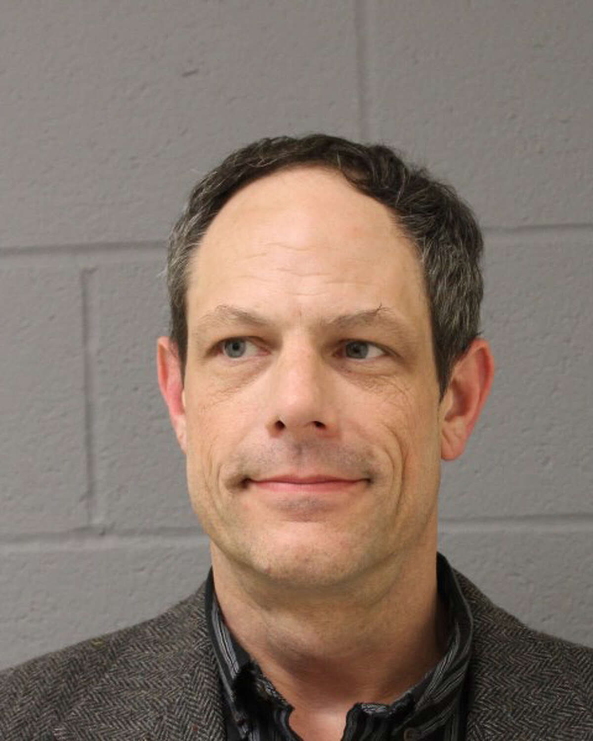 Jason Adams, 46, of Currituck Road, Newtown, was charged Wednesday after police said he brought a gun to work. Adams teaches at Newtown Middle School.