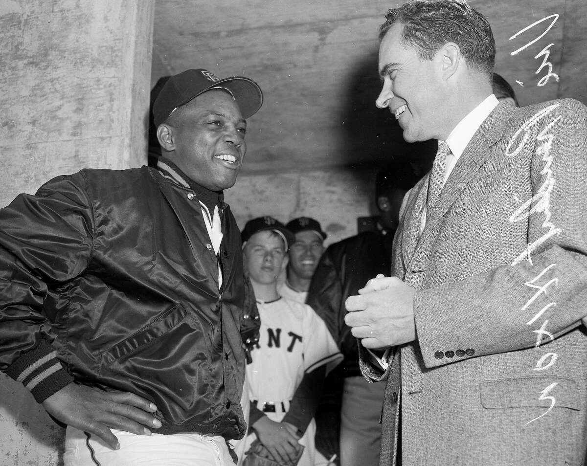 On April 12, 1960, San Francisco Giant Willie Mays chats with then Vice President Richard Nixon in the dugout before opening day at Candlestick Park.