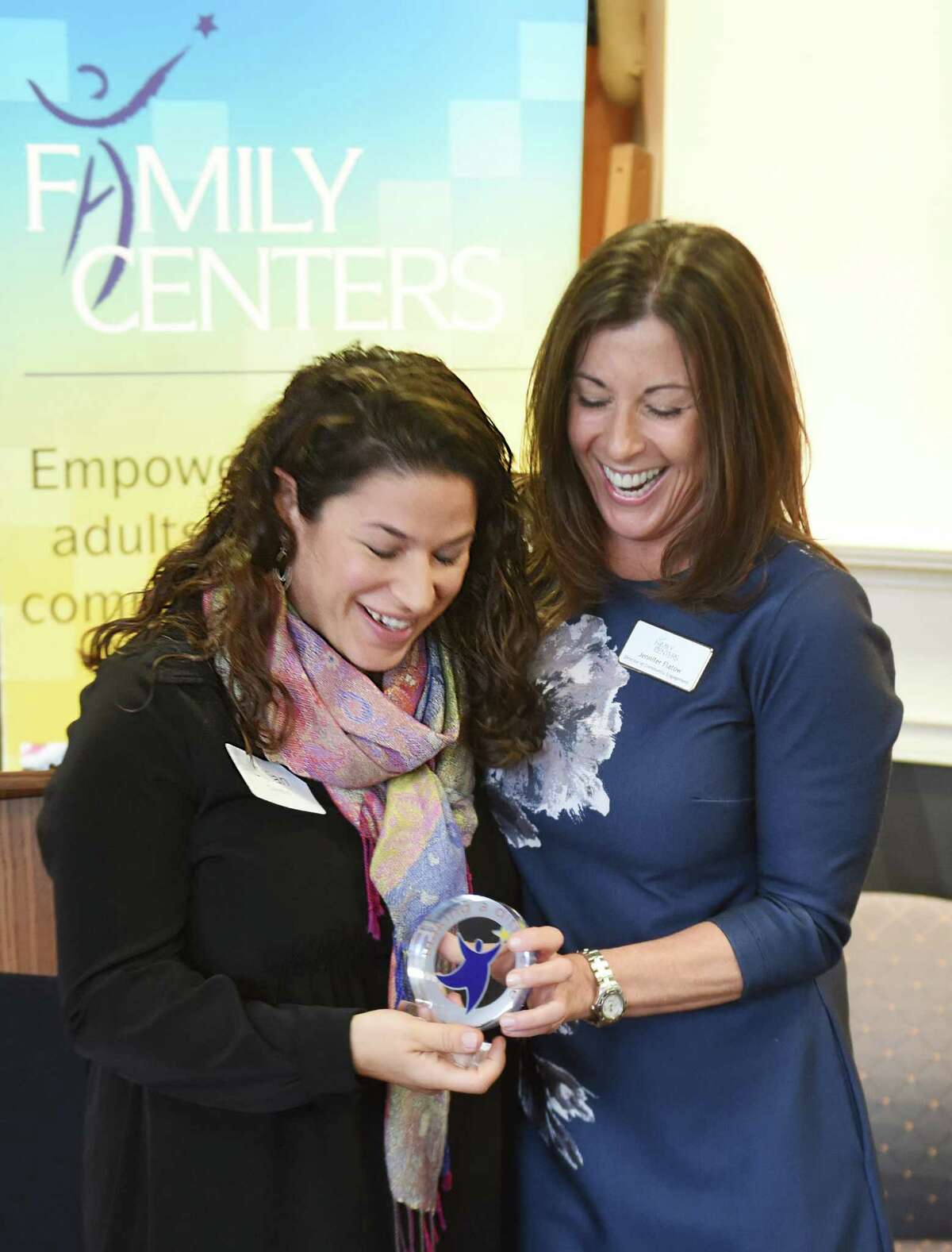 Associate Board Member Jillian Combis, left, accepts an award from Family Centers Director of Community Engagement Jennifer Flatow, right, at the Volunteer Recognition Breakfast at Family Centers in Greenwich, Conn. Thursday, April 7, 2016. In honor of National Volunteer Week, awards volunteer service were presented to employees from Mothers for Others, Morgan Stanley Wealth Management, Greenwich Avenue Apple Store and Family Centers' Board of Directors. Family Centers is a nonprofit organization providing education and services to children, adults and families in Fairfield County through a team of more than 200 employees and 3,000 trained volunteers.