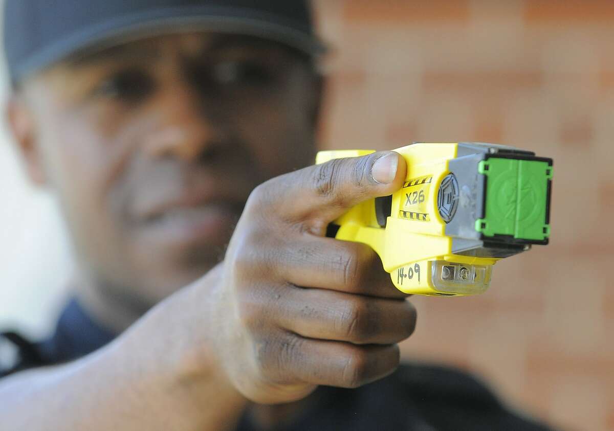 Patrolman Willie Guilford of the Stamford Police Department points a Taser X26 Stun Gun on April 1, 2016. Blacks and Hispanics are shot with stun guns more often in Connecticut, while whites are given the benefit of a warning far more often, a Hearst review of state data from 2015 shows. Stamford police, however, only shot three people with a stun gun last year.
