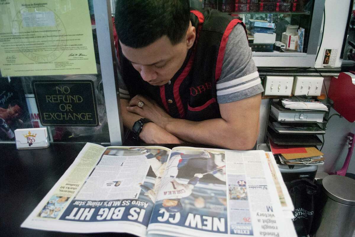 Bronx barber Robert Torres reads about Carlos Correa's emergence in the latest New York City tabloid. "For him to come into Yankee Stadium and blossom, he came out like an All-Star. HeÂ?’s not afraid.Â?”Â ( Hunter Atkins for the Houston Chronicle )