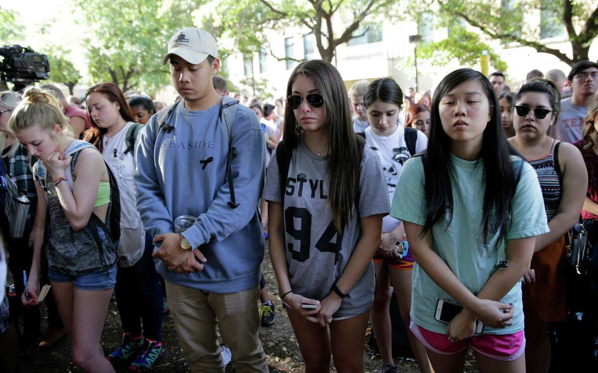 University of Texas students take part in a moment of silence during a gathering on campus for fellow student Haruka Weiser. Her body was found earlier in the week in a wooded area.