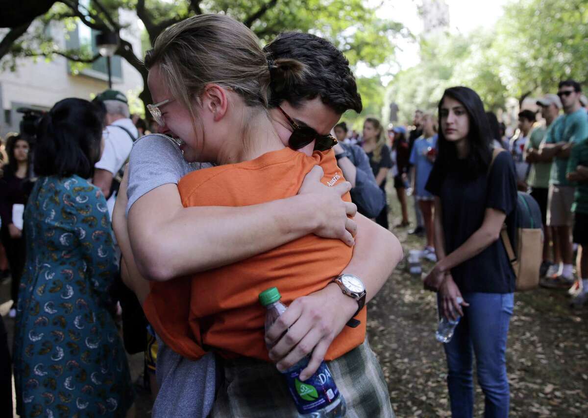 University of Texas students embrace during a gathering for fellow student Haruka Weiser on campus, Thursday, April 7, 2016, in Austin, Texas. Weiser, a first-year theater and dance student from Oregon, was found dead on campus after she was reporter missing earlier this week. (AP Photo/Eric Gay)
