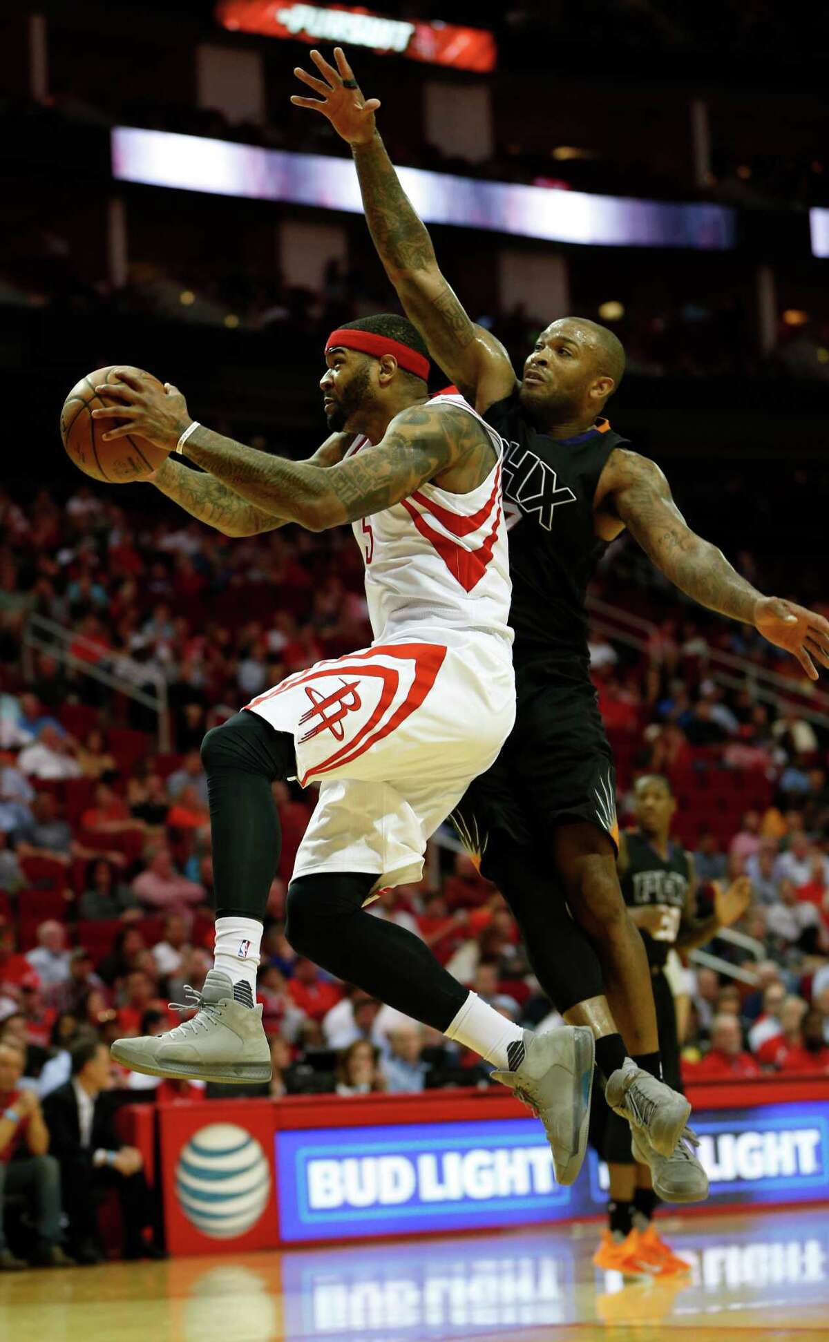 Houston Rockets center Josh Smith (5) goes up for a basket against Phoenix Suns forward P.J. Tucker (17) during the second half of an NBA basketball game at Toyota Center, Thursday, April 7, 2016, in Houston. Rockets lost to Phoenix 124-115.