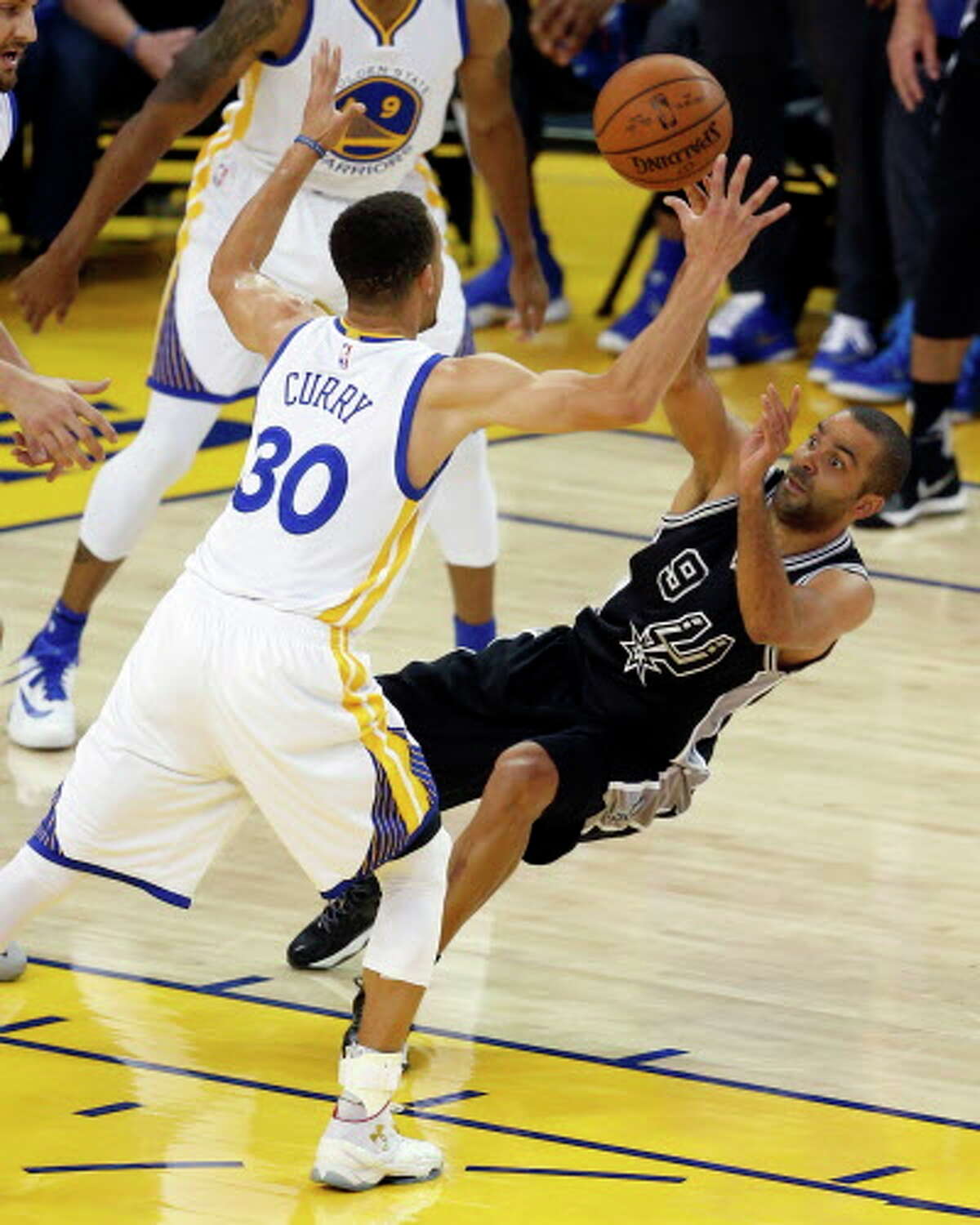 Golden State Warriors' Stephen Curry steals the ball from San Antonio Spurs' Tony Parker in 1st quarter during NBA game at Oracle Arena in Oakland, Calif., on Thursday, April 7, 2016.