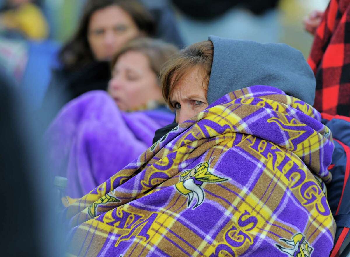 Melanie Semmel bundles up from the cold as she takes in her son, Westhill Hunter Semmel baseball game against Weston. Westhill defeated Weston 3-1 in a boys varsity baseball game at Westhill High School on April 6, 2016.