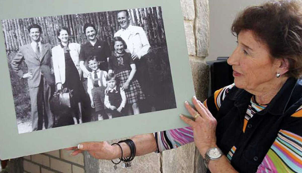 Anita Schorr, in a 2011 photo, holds a picture of her family and another family taken in the spring of 1941. A few weeks later, Schorr and her family would be deported from their home Czech city of Brno to the town of Terezin, which German forces ran as a Jewish ghetto during World War II. They later were dispatched to concentration camps.