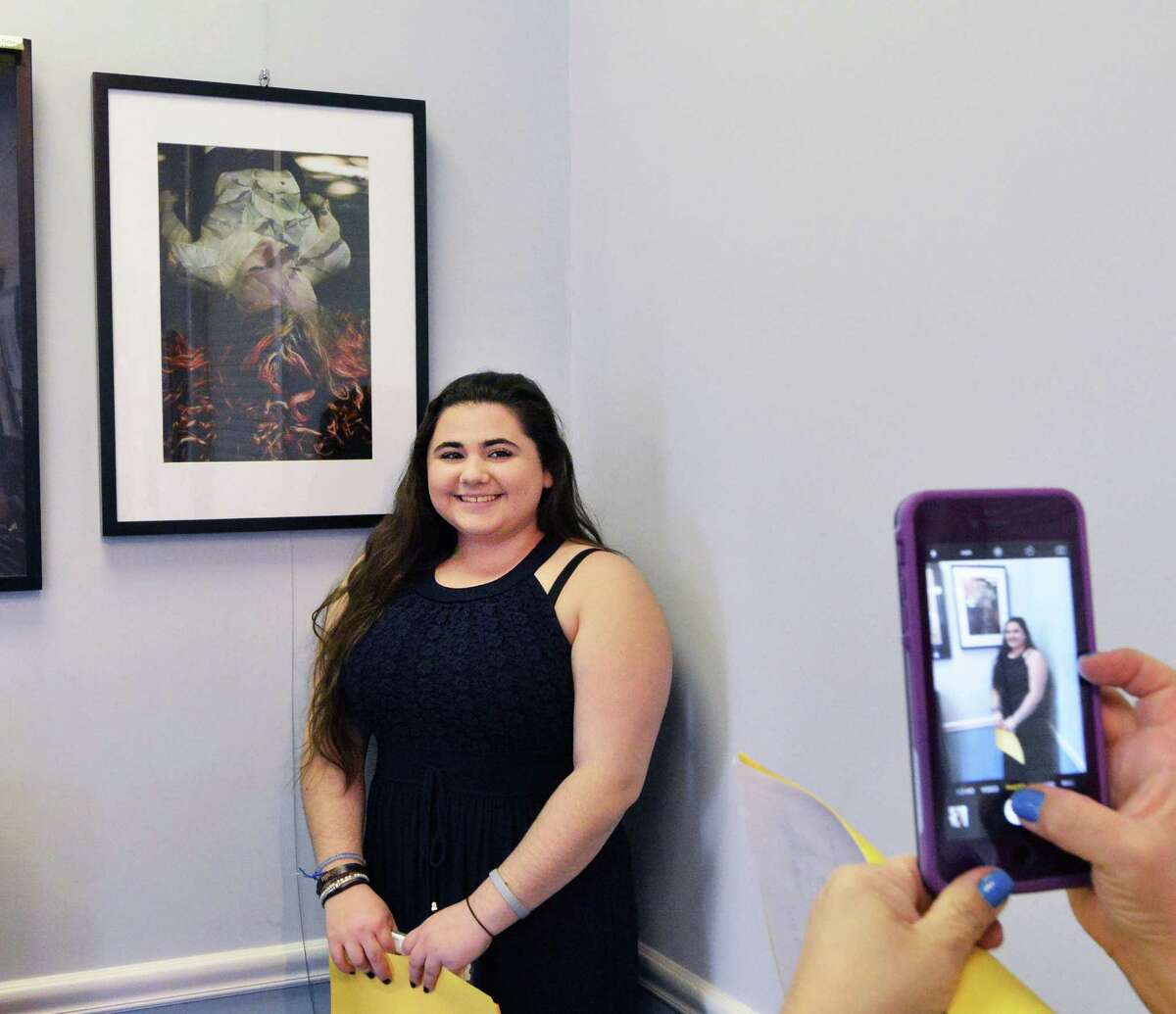 Greenwich High School senior Estella Perrone,18, with her surrealistic photography work that was part of the Art Society of Old Greenwich Spring Art Show at the Garden Education Center in Cos Cob, Friday night, April 8, 2016. Perrone was one of three GHS student scholarship award winners along with Monica Stevenson for a charcoal portrait and Andreas Zervos for ceramics. Barbara Stretton of the Art Society of Old Greenwich said there are about 35 works in the show and that the show will be available for viewing at the center until April 29th. According to Stretton viewing hours are during the week, Monday to Friday, 9 am to 4 pm.