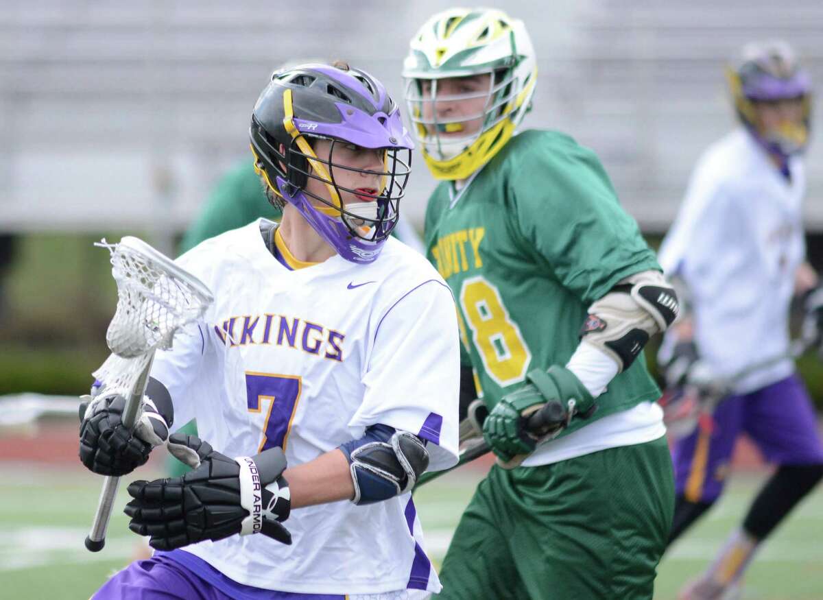 Westhill Will Hallett (7) looks inside on Trinity defenders in a boys lacrosse game at Westhill High School in Stamford on April 8, 2016. Westhill defeated Trinity 6-4.