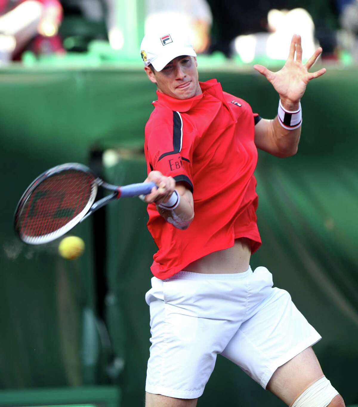 John Isner (USA) returns a hit to Hyeon Chung (KOR) in a quarter final match at the U.S. Men's Clay Court Championships at River Oaks Country Club, Friday, April 8, 2016, in Houston, Texas. Isner won, 7-6(5), 6-4.