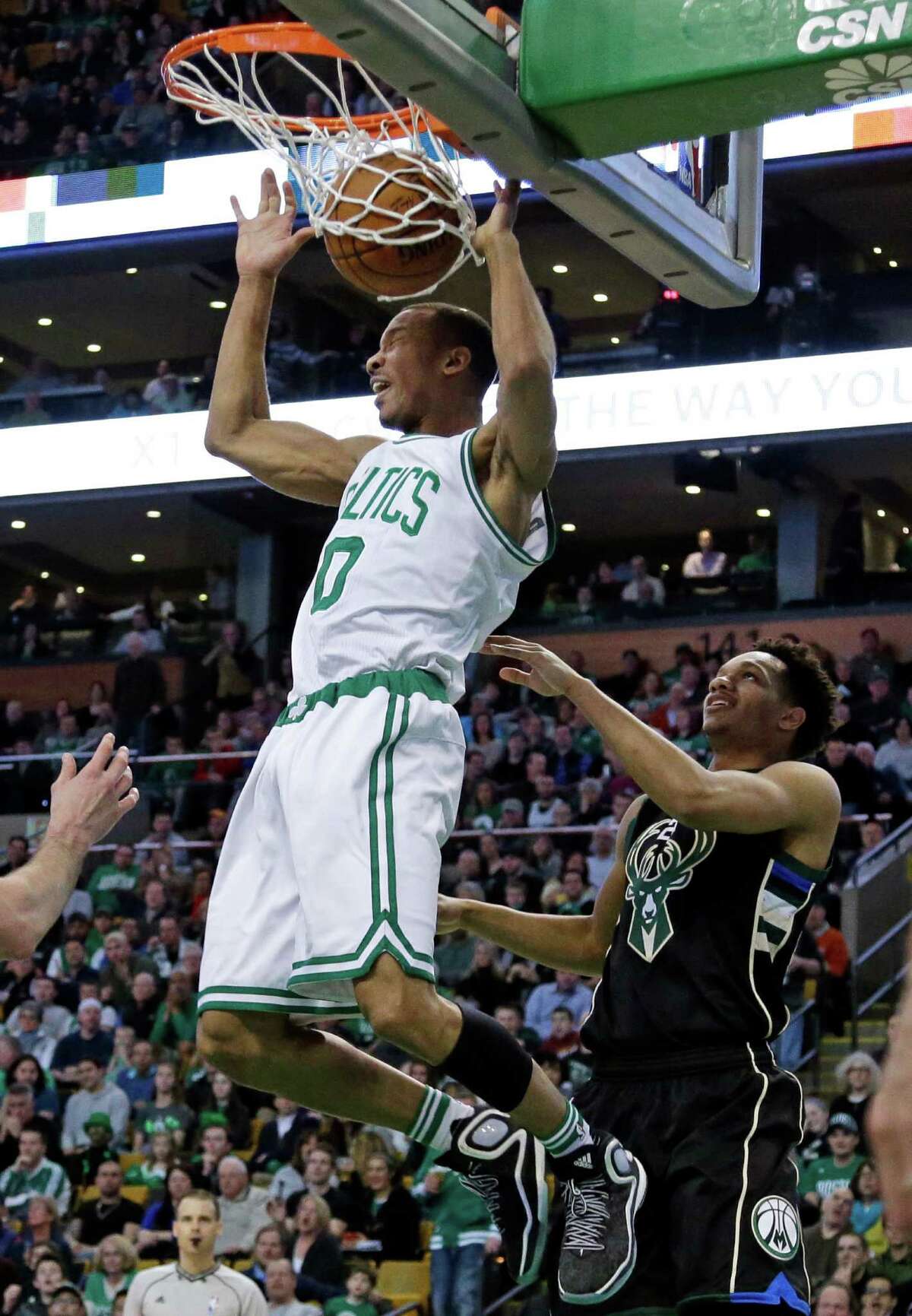 Boston Celtics guard Avery Bradley (0) dunks against Milwaukee Bucks guard Rashad Vaughn (20) in the first half of an NBA game, Friday, April 8, 2016, in Boston. (AP Photo/Elise Amendola) ORG XMIT: MAEA102