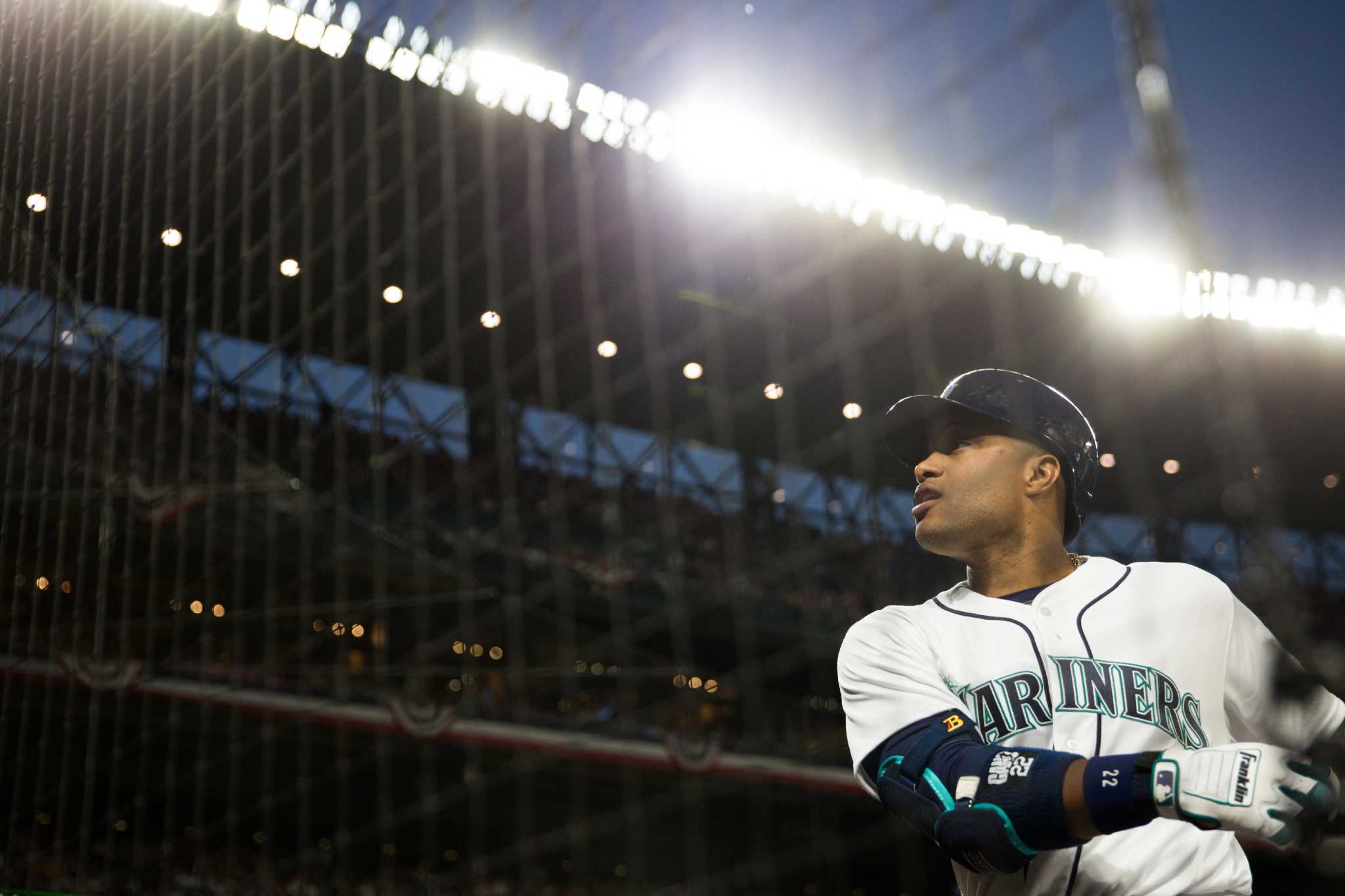 Former Seattle Mariners pitcher Felix Hernandez, front right, talks with  manager Scott Servais, left, after being inducted into the Mariners Hall of  Fame before a baseball game between the Mariners and the