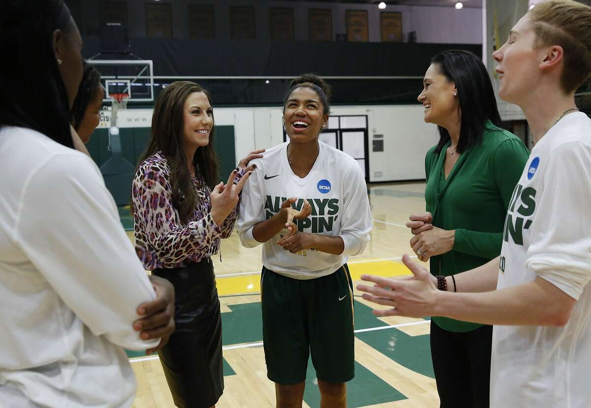 Between portrait photos, Don's women's basketball head coach Jennifer Azzi, second from right, jokes with women's basket ball associate head coach Blair Hardiek, third from left and players, from left, Hashima Carothers, Claudia Price, Kalyn Simon and Rachel Howard in the gym at University of San Francisco April 7, 2016 in San Francisco, Calif.