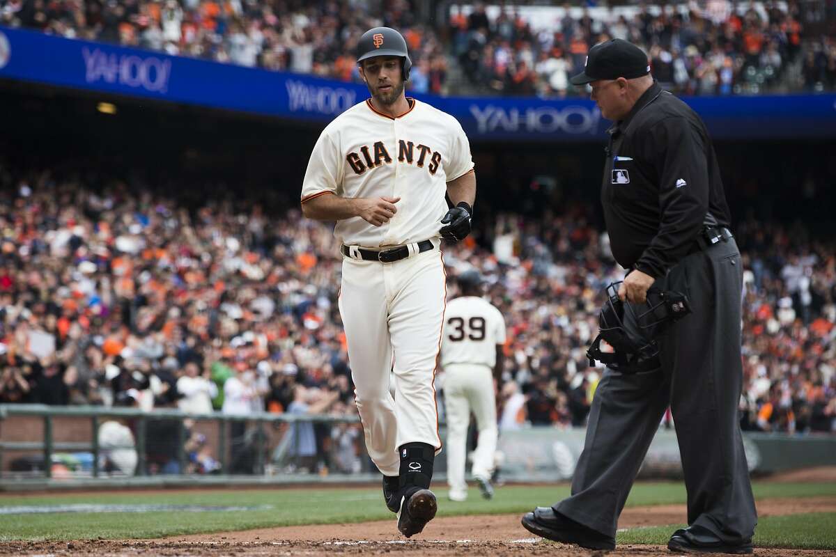 San Francisco Giants starting pitcher Madison Bumgarner (40) scores after hitting a solo home run during the second inning against the Los Angeles Dodgers at AT&T Park in San Francisco, Calif. on Saturday, April 9, 2016. The Dodgers defeated the Giants 3-2.