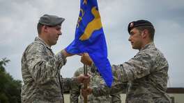 Lt. Col. William Schroeder, 342nd Training Squadron commander, receives the squadron flag from Maj. Timothy Hahn, 342nd TRS, Detachment 3 commander, during the Det. 3 deactivation ceremony on Hurlburt Field, Fla., July 31, 2015. The detachment, commonly referred to as the Tactical Air Control Party Schoolhouse, officially transferred to Joint Base San Antonio-Lackland, Texas. (U.S. Air Force photo/Senior Airman Christopher Callaway)