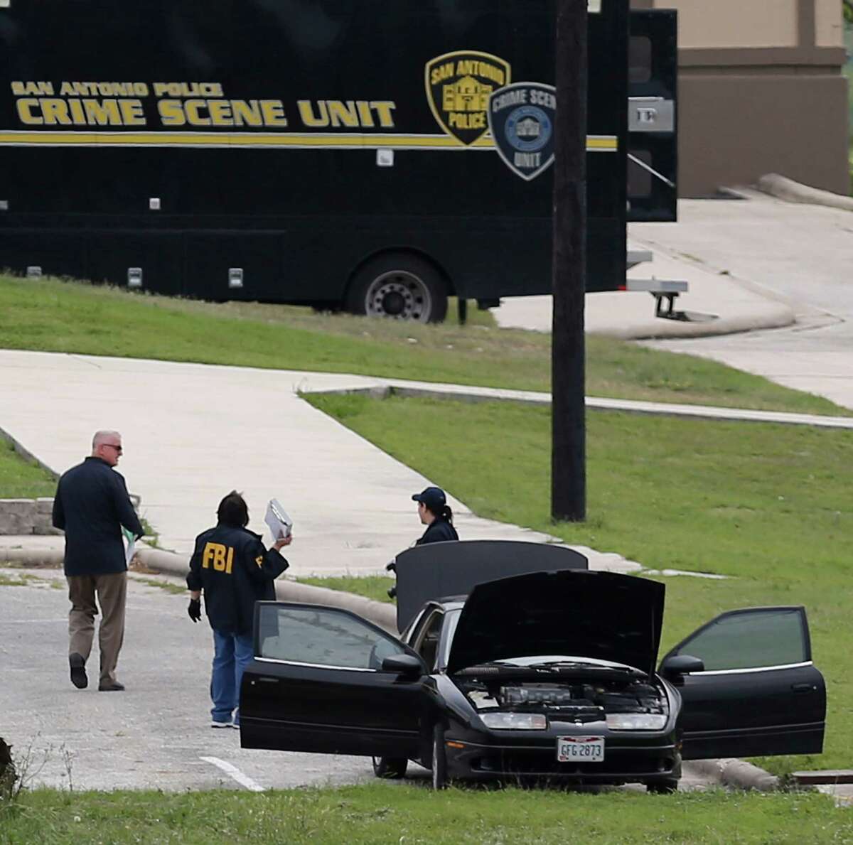 FBI personnel stand near a vehicle located inside Lackland AFB, Medina Annex on Friday, Apr. 8, 2016. Earlier, two men died in an apparent murder-suicide near Forbes Hall within the annex Friday morning that left the base locked down for nearly 2 hours, officials said. (Kin Man Hui/San Antonio Express-News)