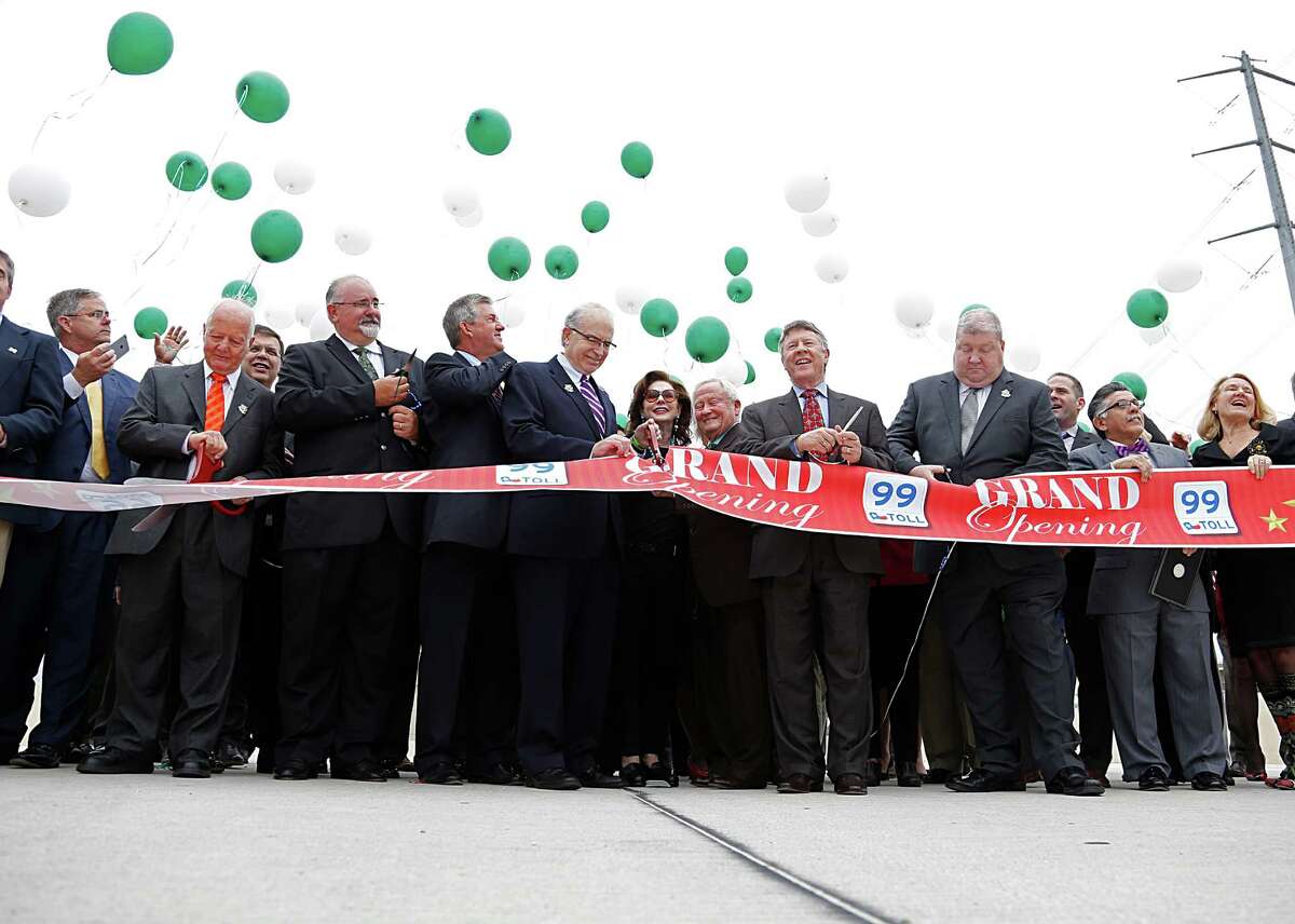 Officials and others cut the ribbon and release balloons during the Texas Department of Transportation ribbon cutting celebration for the completion of the newest segment of the Grand Parkway on March 29.