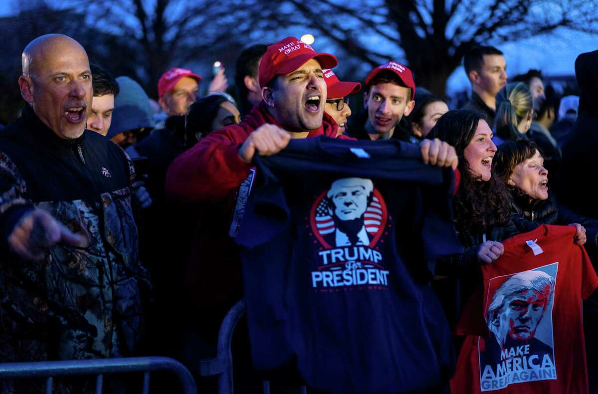 Donald Trump supporters yell toward people protesting Trump near the site of a campaign appearance by Republican presidential candidate Donald Trump in Bethpage, New York, Wednesday, April 6, 2016. (AP Photo/Craig Ruttle) ORG XMIT: NYCR112