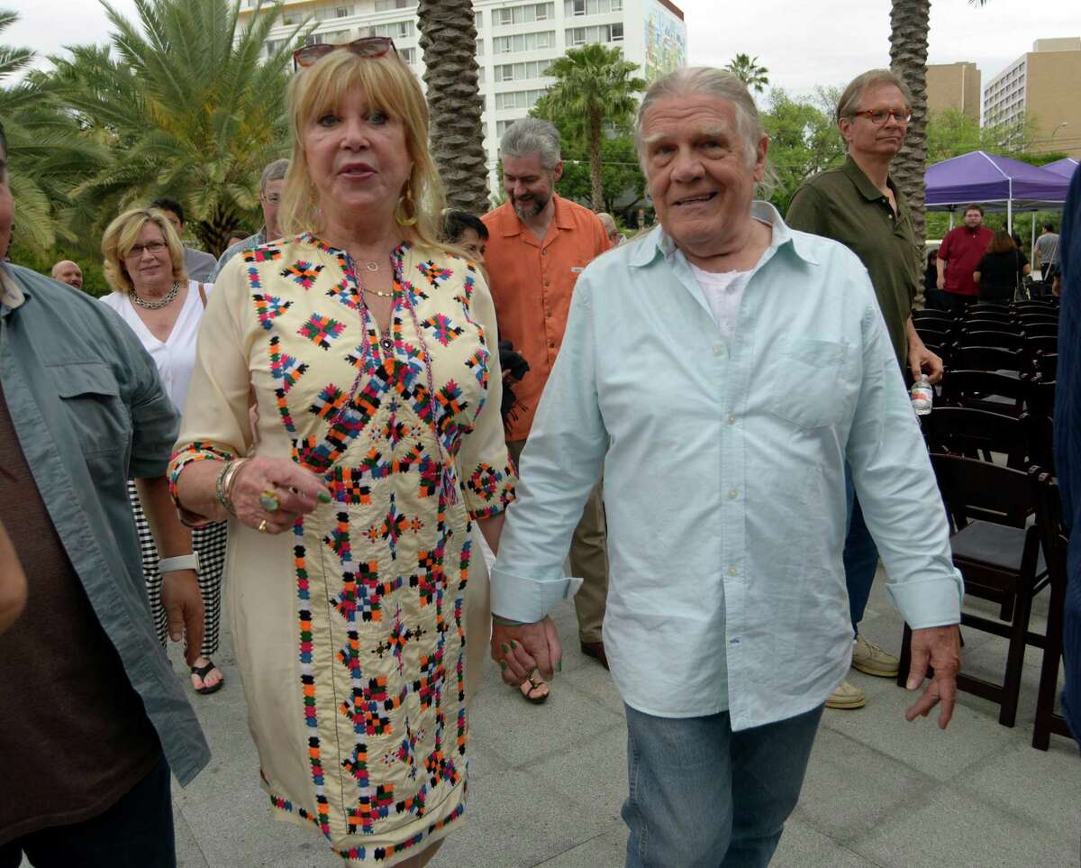 Photographer and model Pattie Boyd, left, who is the former wife of George Harrison of the Beatles and Eric Clapton, walks with legendary photographer Henry Diltz, who shot some of the most iconic album covers of the 1960s and 1970s, at the Tobin Center for the Performing Arts on Saturday, April 9, 2016.