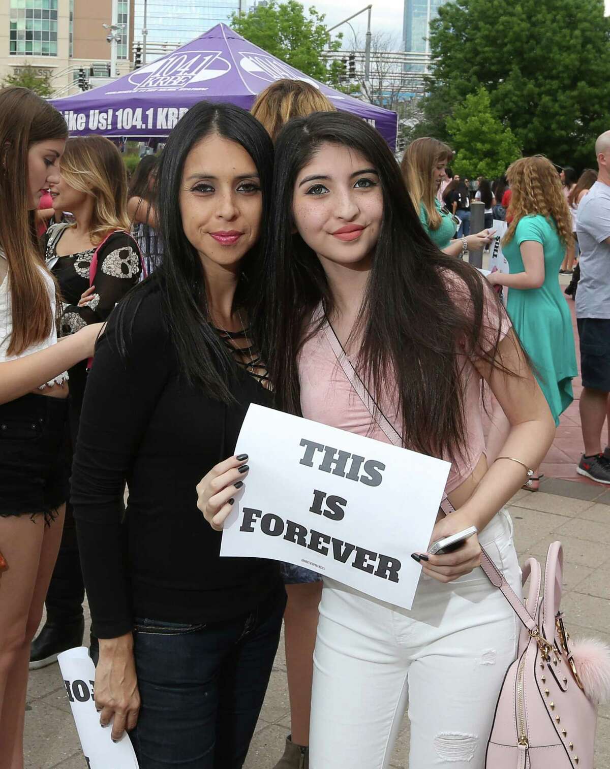 People pose for a photo before the Justin Bieber concert at the Toyota Center Saturday, April 9, 2016, in Houston.