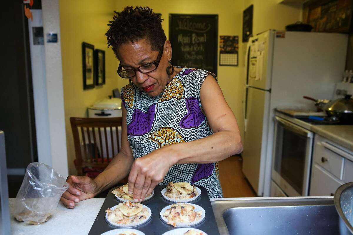 Renee McGhee sprinkles brown sugar on bread pudding, as she bakes in her kitchen in Berkeley, California, on Thursday, April 7, 2016. Renee works for a website called Josephine, where she makes meals in her kitchen and customers come to her home to pick up food after purchasing through the site.
