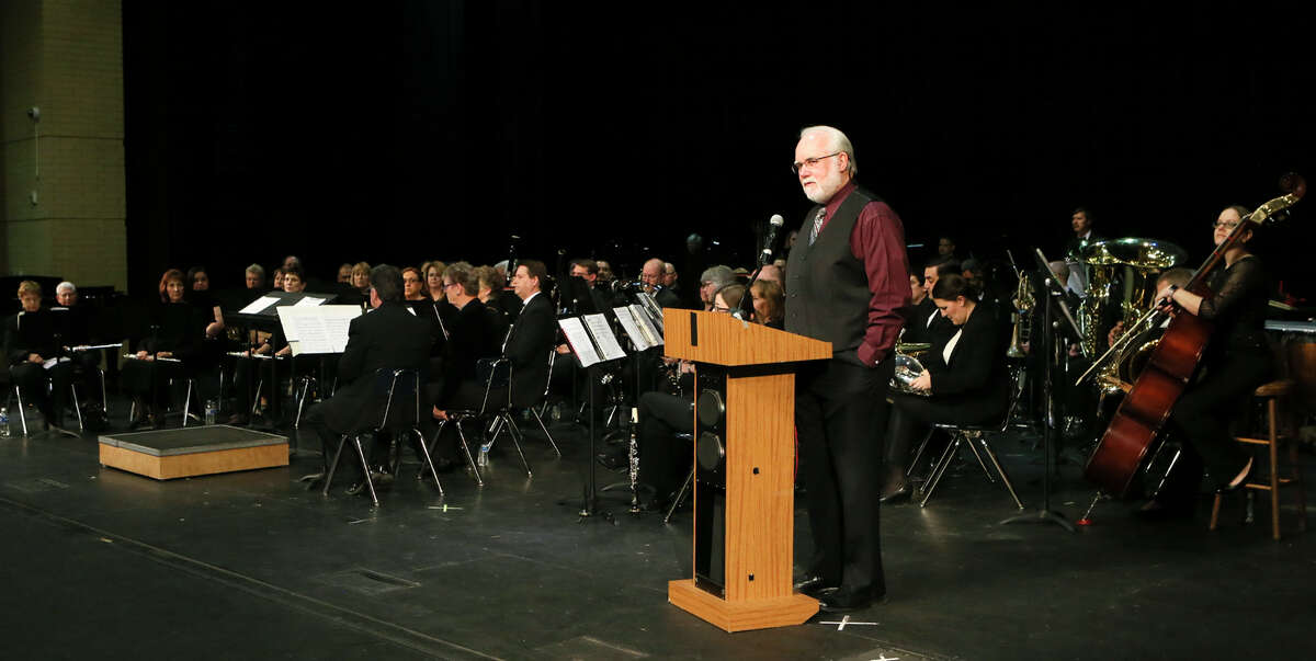Helotes Mayor Tom Schoolcraft introduces the Helotes Area Community Band to start a free concert, "Music, Melodies and Dances," at John Marshall High School, on Sunday, April 3, 2016. Schoolcraft proposed in 2008 the formation of a community band, which he envisioned would have a few fiddlers and guitars, to play at city events and serve as community ambassadors. Instead, the small city wound up with a 70-piece orchestra. MARVIN PFEIFFER/ mpfeiffer@express-news.net