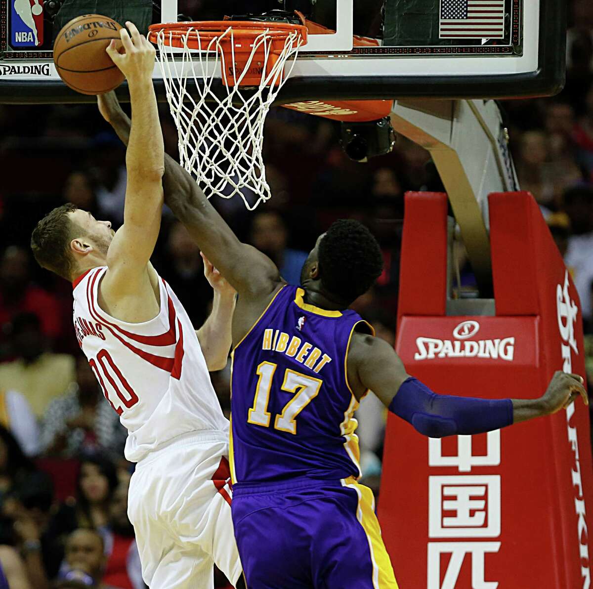 Houston Rockets forward Donatas Motiejunas left, collides with Los Angeles Lakers center Roy Hibbert during the second half of NBA game action at the Toyota Center Sunday, April 10, 2016, in Pearland.