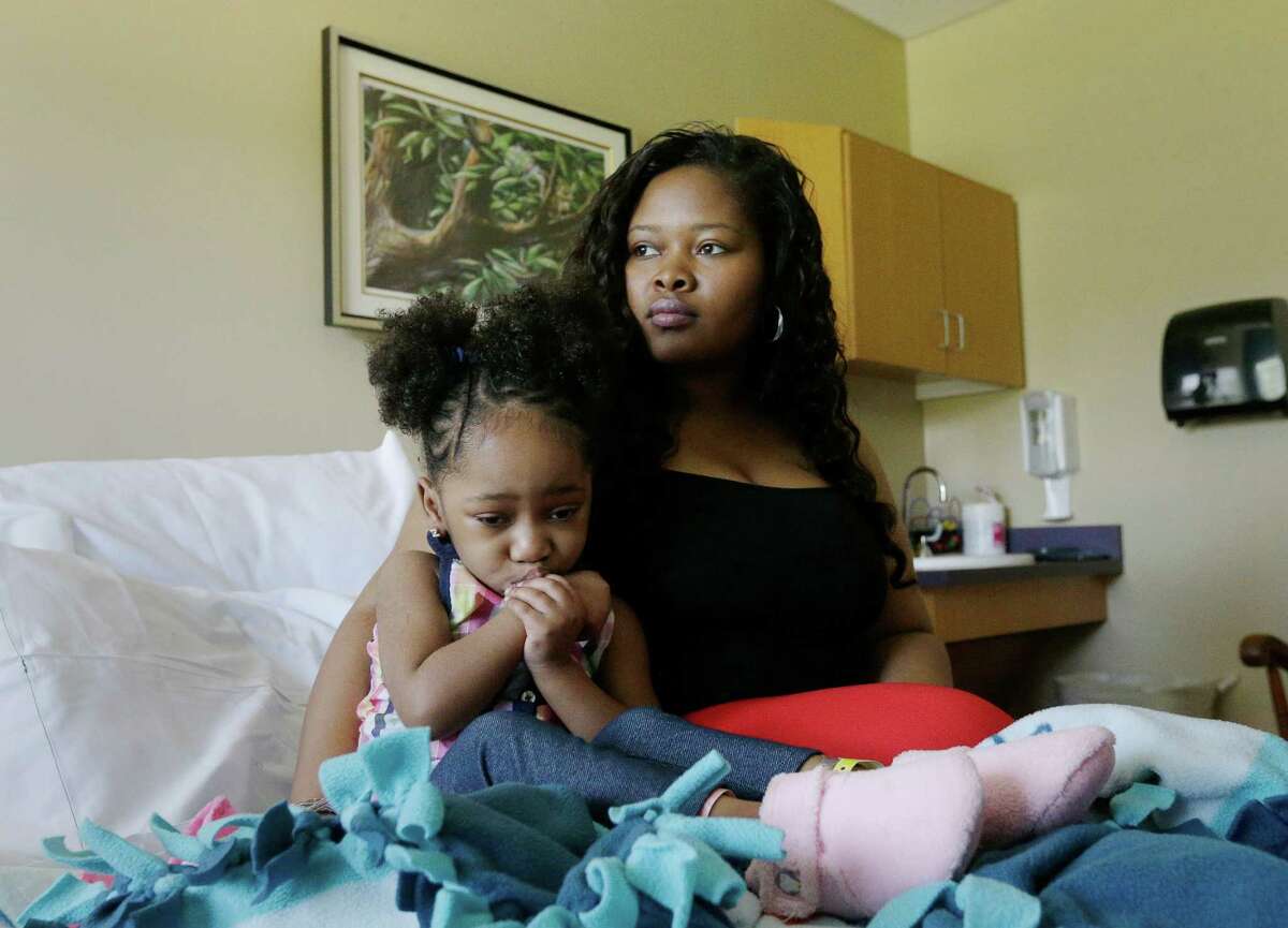 Courissa Hall, right, poses for a portrait with her daughter Nevaeh, 4, at a specialty and rehabilitation hospital in west Houston Thursday, April 7, 2016, in Houston. Nevaeh suffered brain damage during a dental procedure.